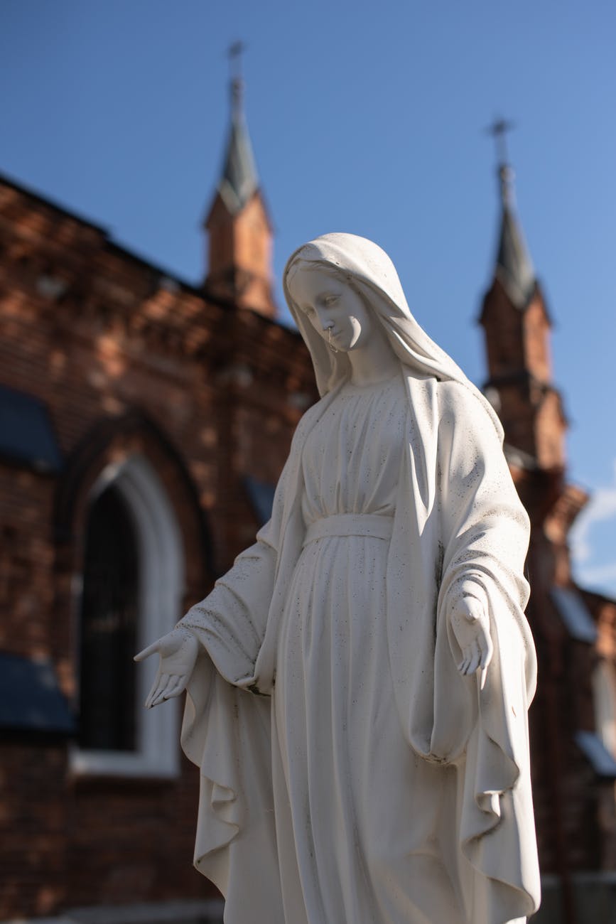 white concrete statue of virgin mary