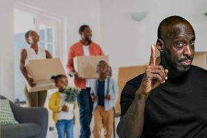 Beautiful african american family with two children carrying boxes in a new home. Cheerful mature mother and mid adult father holding boxes while entering new home with son and daughter. Happy son and daughter helping parents relocating in new house with excitement on their faces.